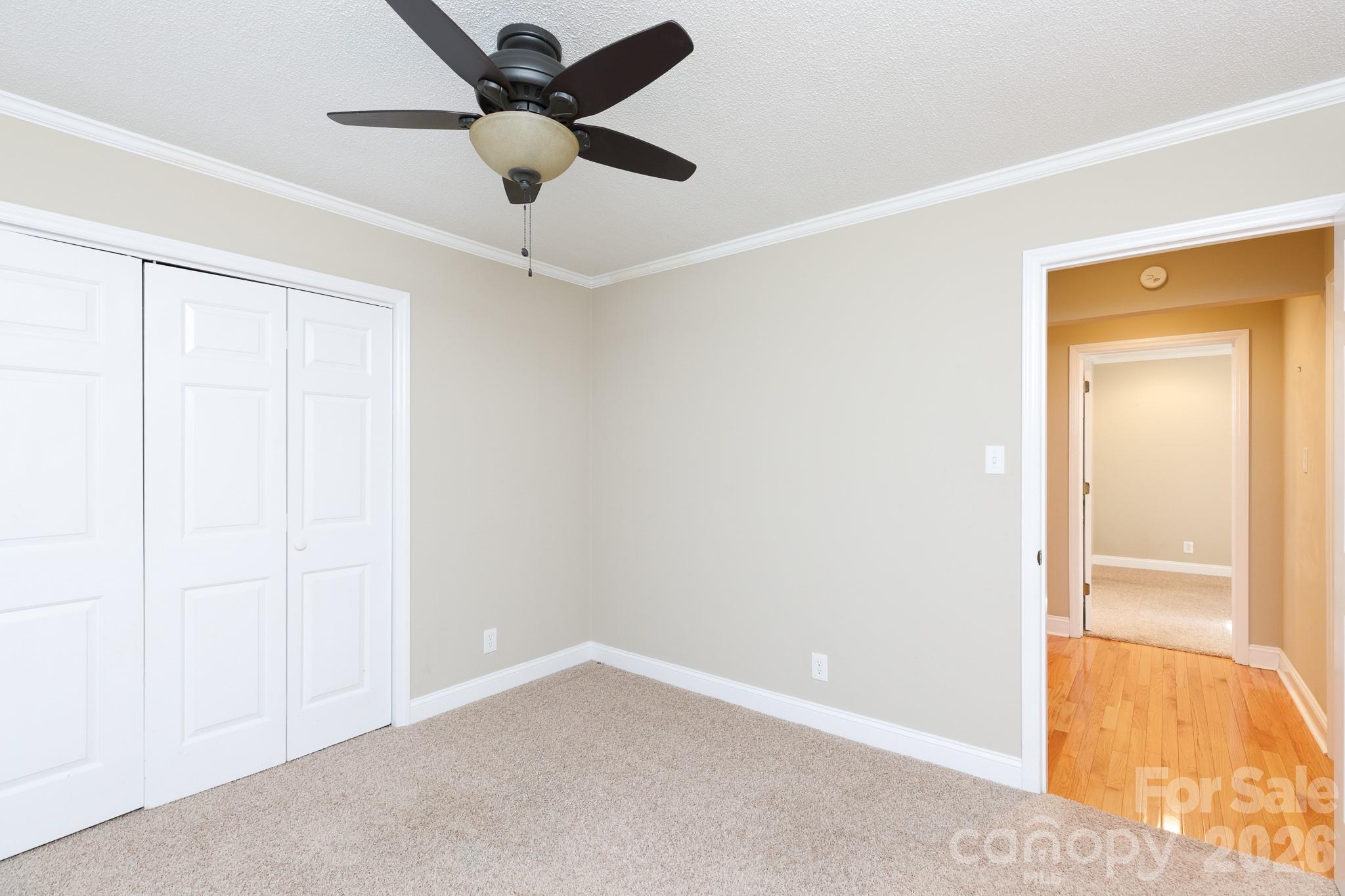 4193 Walker Road Rock Hill, SC 29730 - Photo 15 of 38 an empty room with a ceiling fan and carpet