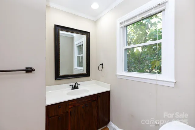 a bathroom with a sink vanity and a mirror