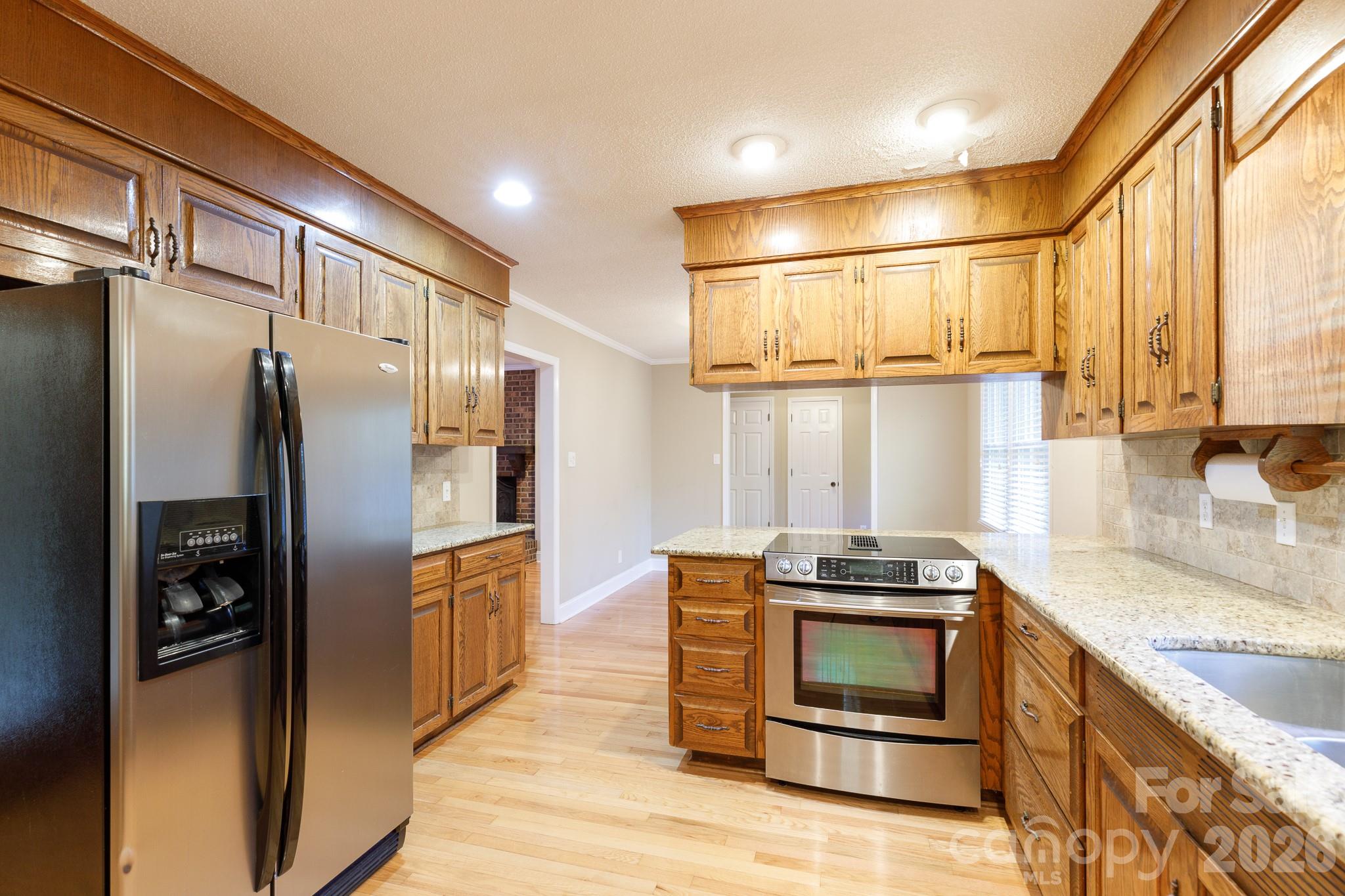4193 Walker Road Rock Hill, SC 29730 - Photo 18 of 38 a kitchen with stainless steel appliances granite countertop a refrigerator and a stove