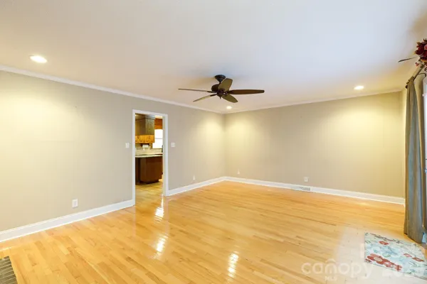 a view of an empty room with a fireplace and a window