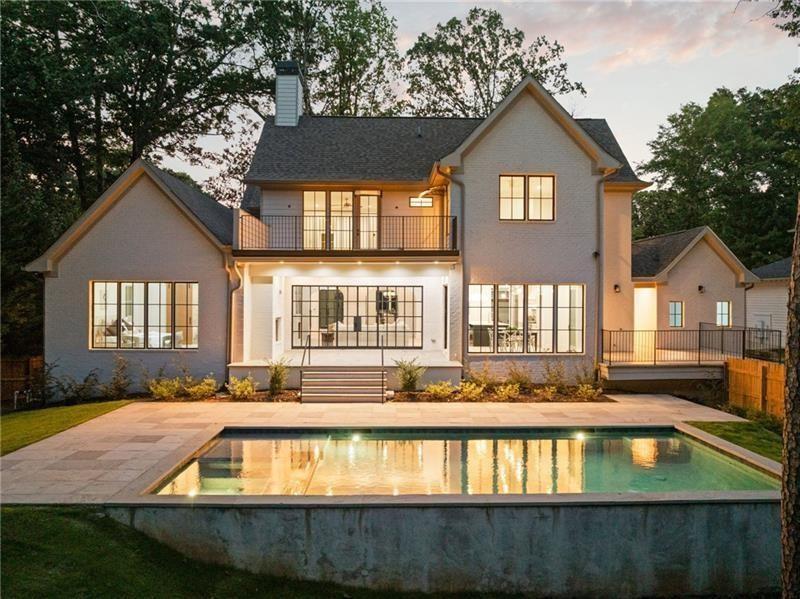 1074 Moores Mill Road Northwest Atlanta, GA 30327 - Photo 1 of 68 a front view of a house with a yard