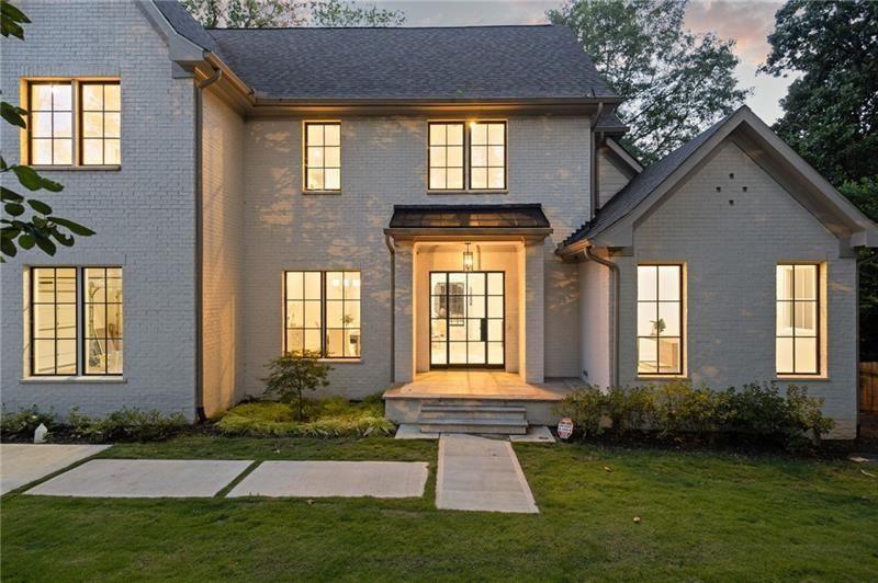 1074 Moores Mill Road Northwest Atlanta, GA 30327 - Photo 2 of 68 a front view of a house with a yard