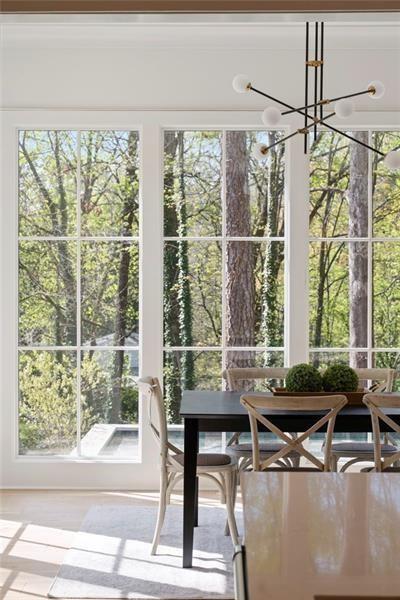 1074 Moores Mill Road Northwest Atlanta, GA 30327 - Photo 25 of 68 a room with wooden floor and outdoor seating