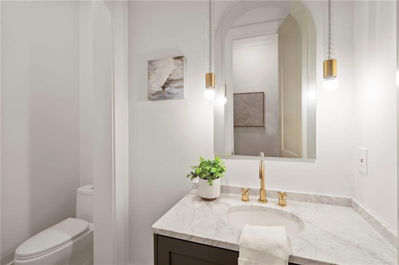 1074 Moores Mill Road Northwest Atlanta, GA 30327 - Photo 28 of 68 a bathroom with a granite countertop sink a toilet and mirror