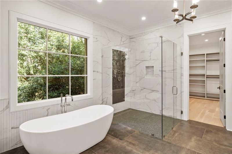 1074 Moores Mill Road Northwest Atlanta, GA 30327 - Photo 34 of 68 a bathroom with a bathtub and a shower