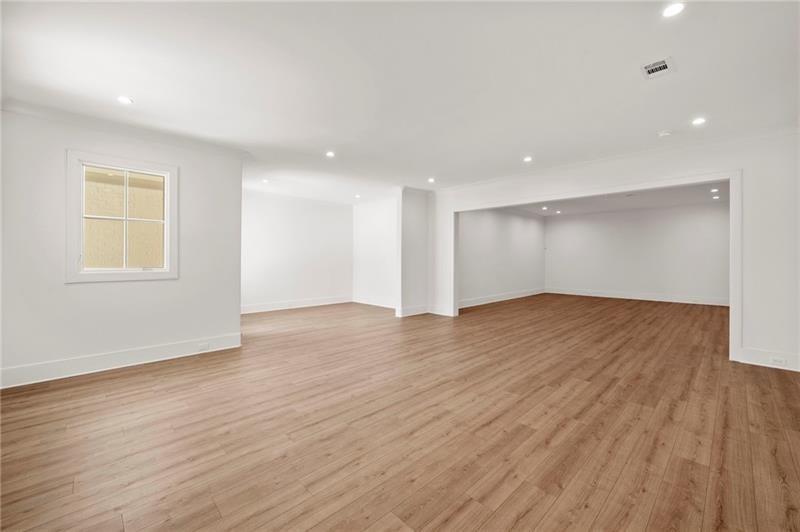 1074 Moores Mill Road Northwest Atlanta, GA 30327 - Photo 40 of 68 a view of empty room with wooden floor and fan