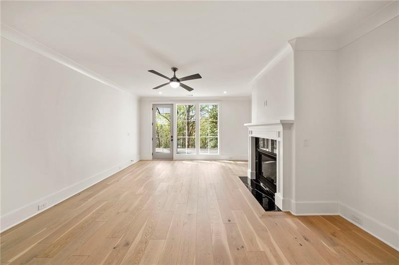 1074 Moores Mill Road Northwest Atlanta, GA 30327 - Photo 43 of 68 wooden floor in an empty room with a fireplace
