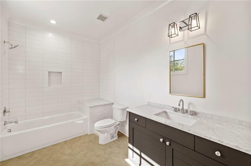 1074 Moores Mill Road Northwest Atlanta, GA 30327 - Photo 53 of 68 a bathroom with a granite countertop sink a toilet and shower