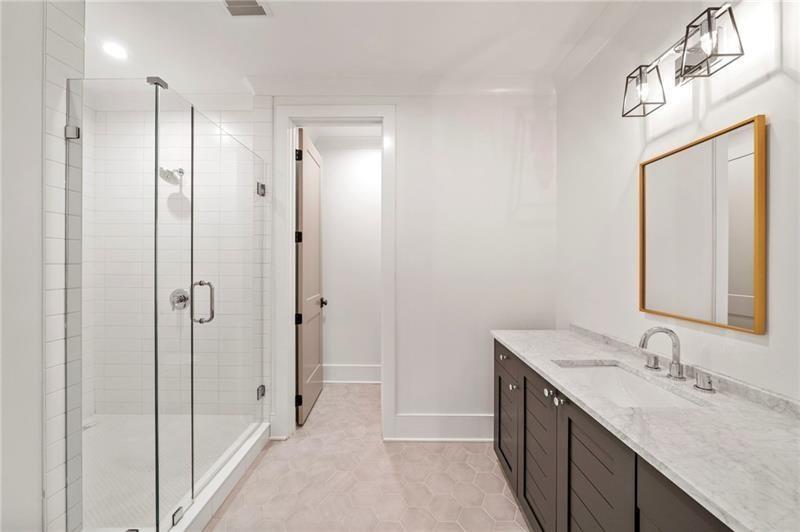 1074 Moores Mill Road Northwest Atlanta, GA 30327 - Photo 56 of 68 a bathroom with a double vanity sink mirror and shower
