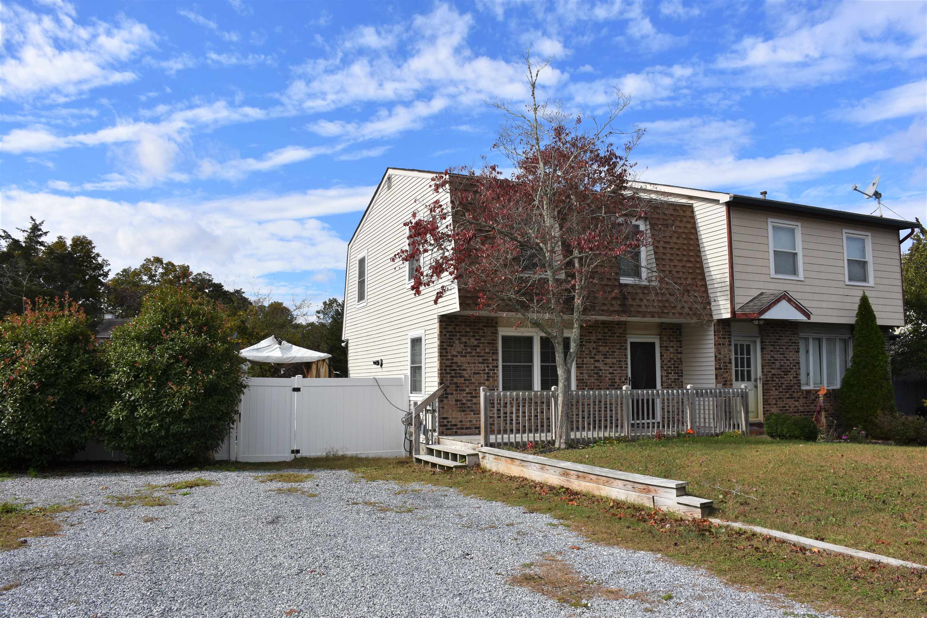28 New Bridge Road Seaville, NJ 08230 - Photo 3 of 29 a view of a white house with large windows and a small yard