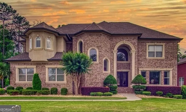 a front view of a house with yard and garage