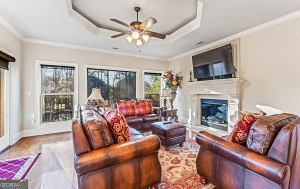 a living room with furniture and wooden floor