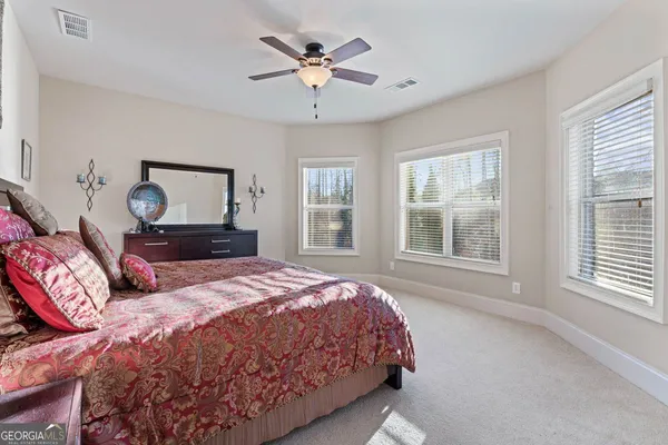 a bathroom with a granite countertop toilet a sink and a mirror