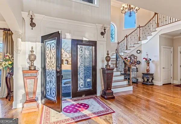 a view of a dining room with furniture and chandelier