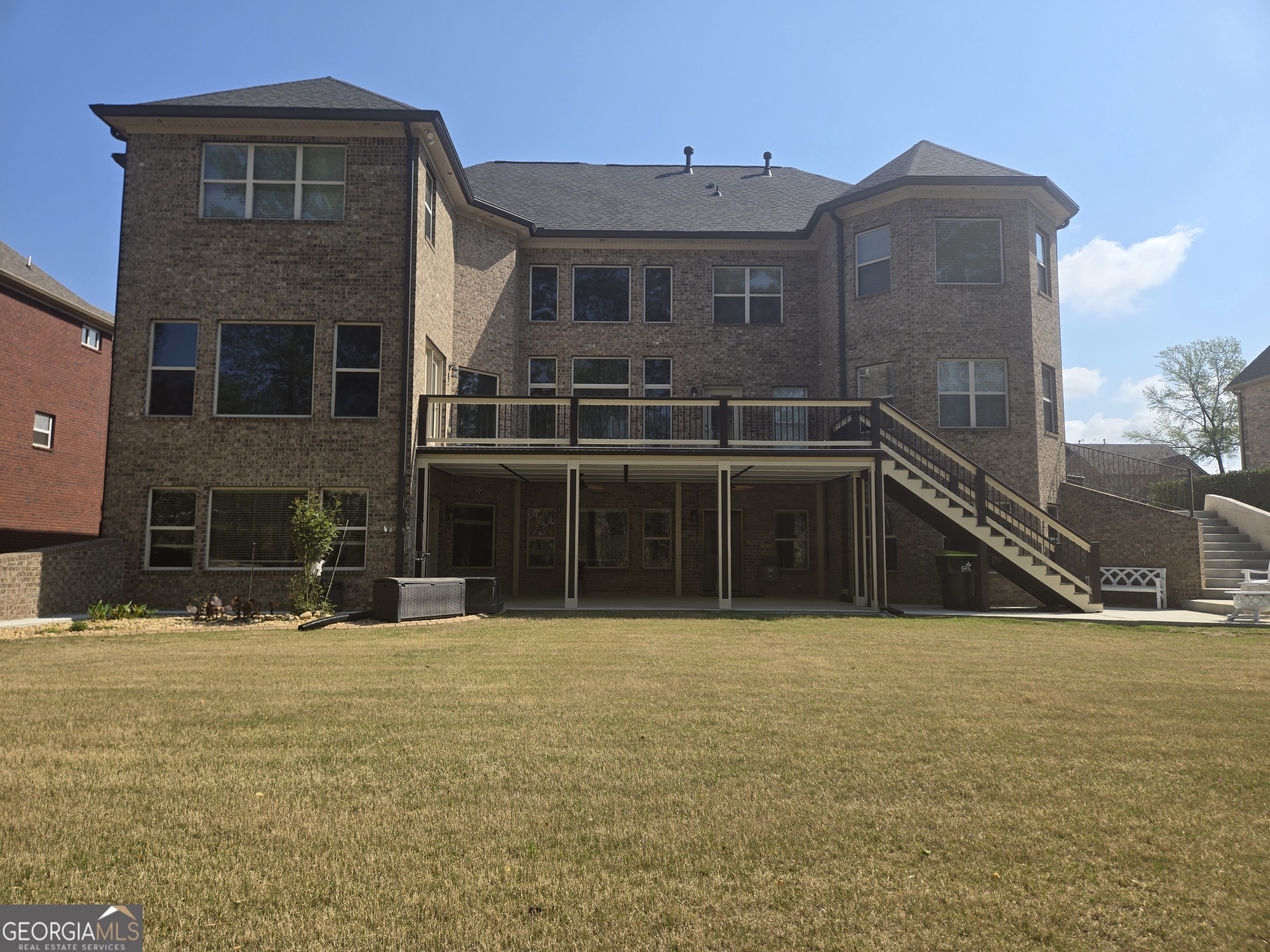 376 Masters Club Boulevard Hampton, GA 30228 - Photo 57 of 68 a view of a brick house with many windows