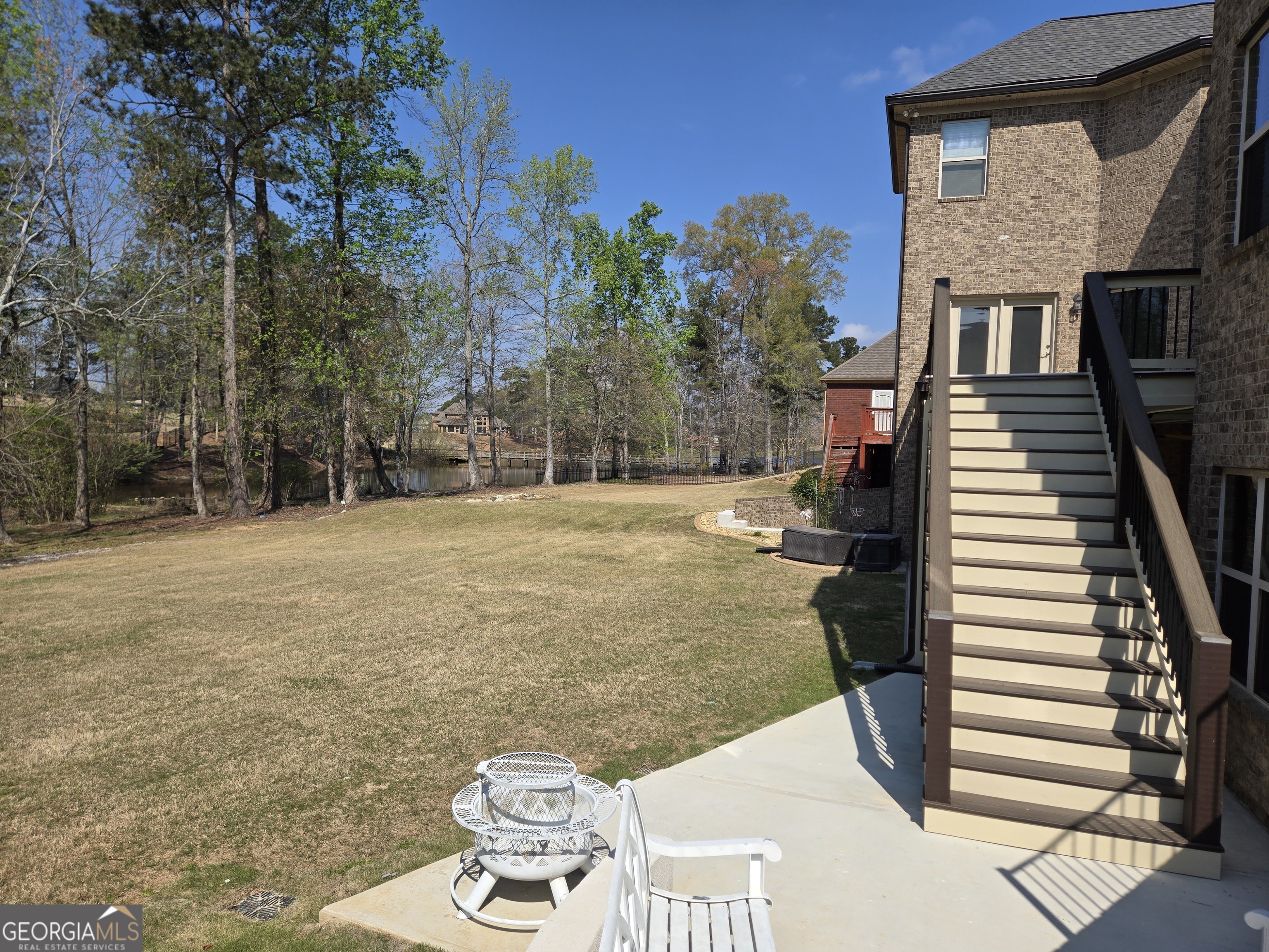 376 Masters Club Boulevard Hampton, GA 30228 - Photo 63 of 68 a backyard of a house with table and chairs
