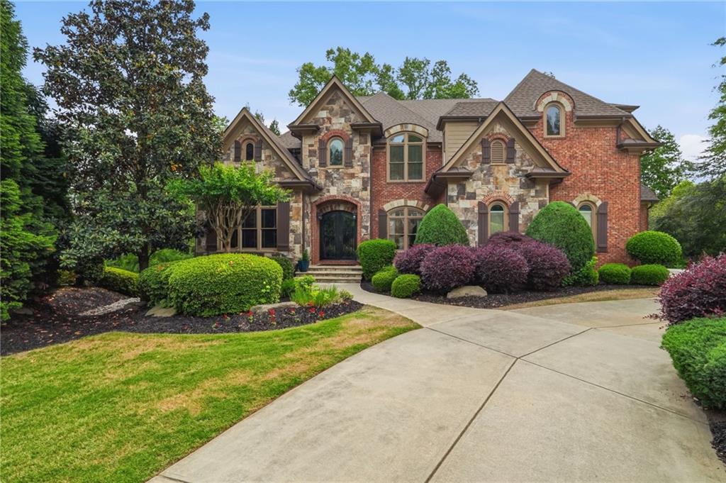 8340 Colonial Place Duluth, GA 30097 - Photo 2 of 74 a front view of a house with a yard