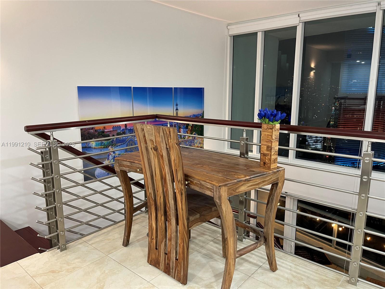 41 Southeast 5th Street, Unit 2305 Miami, FL 33131 - Photo 28 of 56 a kitchen with a table and chairs