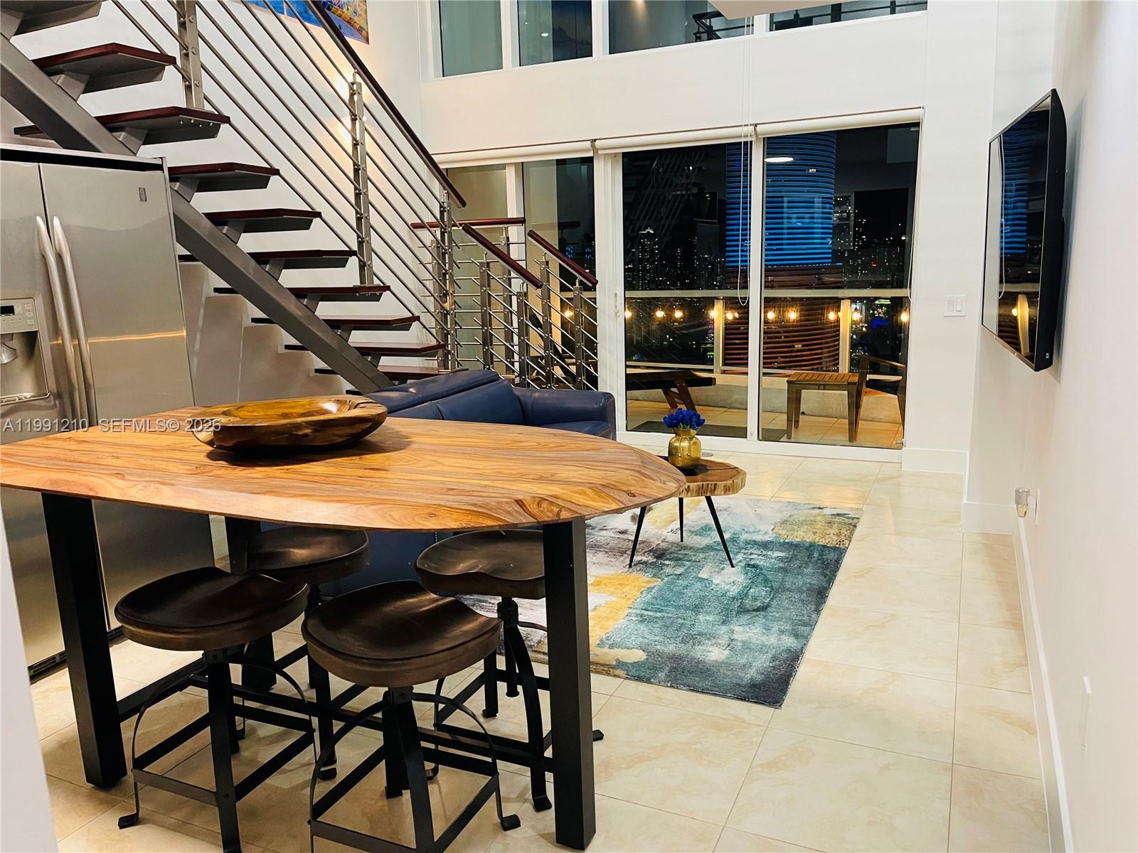 41 Southeast 5th Street, Unit 2305 Miami, FL 33131 - Photo 39 of 56 a view of a dinning tables and chairs in the balcony