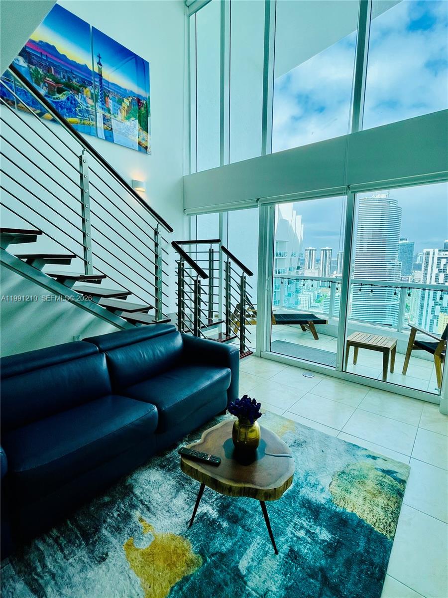 41 Southeast 5th Street, Unit 2305 Miami, FL 33131 - Photo 4 of 56 a living room with furniture and a potted plant