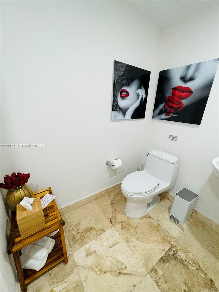 41 Southeast 5th Street, Unit 2305 Miami, FL 33131 - Photo 42 of 56 a bathroom with a toilet and a shower