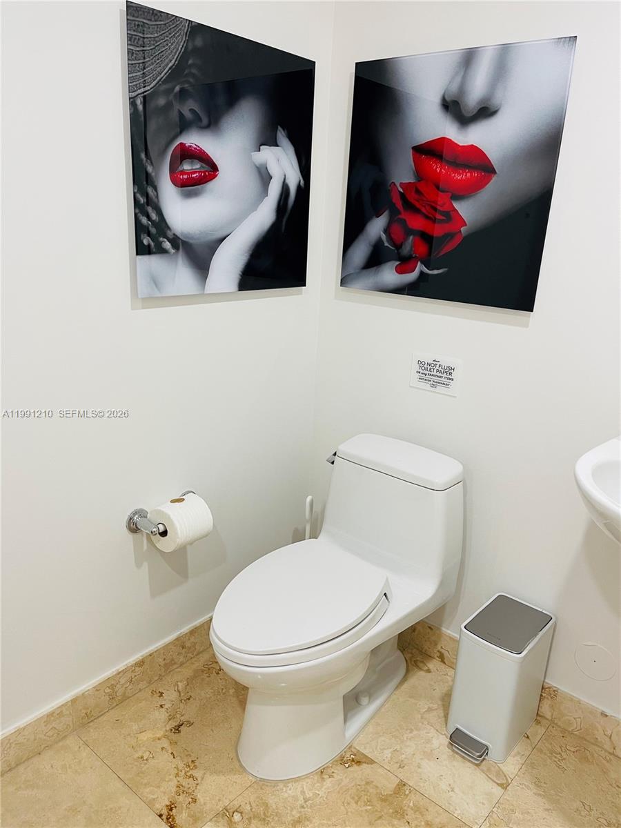 41 Southeast 5th Street, Unit 2305 Miami, FL 33131 - Photo 43 of 56 a bathroom with a toilet and a sink
