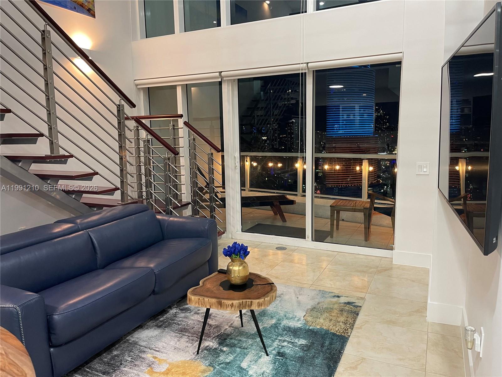 41 Southeast 5th Street, Unit 2305 Miami, FL 33131 - Photo 46 of 56 a balcony with furniture and rug