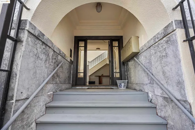 a view of staircase with white walls and a potted plant