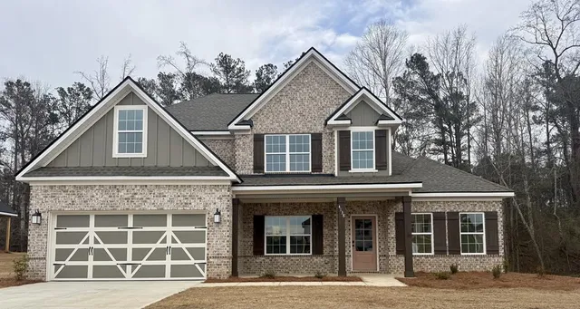 a front view of a house with a garden