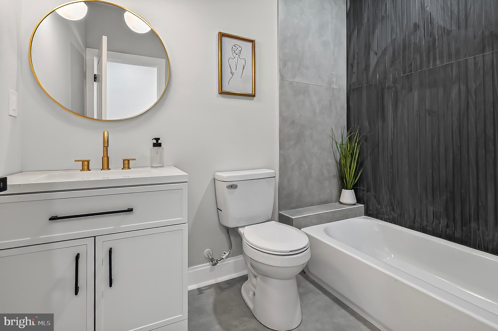 539 East 23rd Street Baltimore, MD 21218 - Photo 12 of 29 a bathroom with a sink toilet and a bathtub