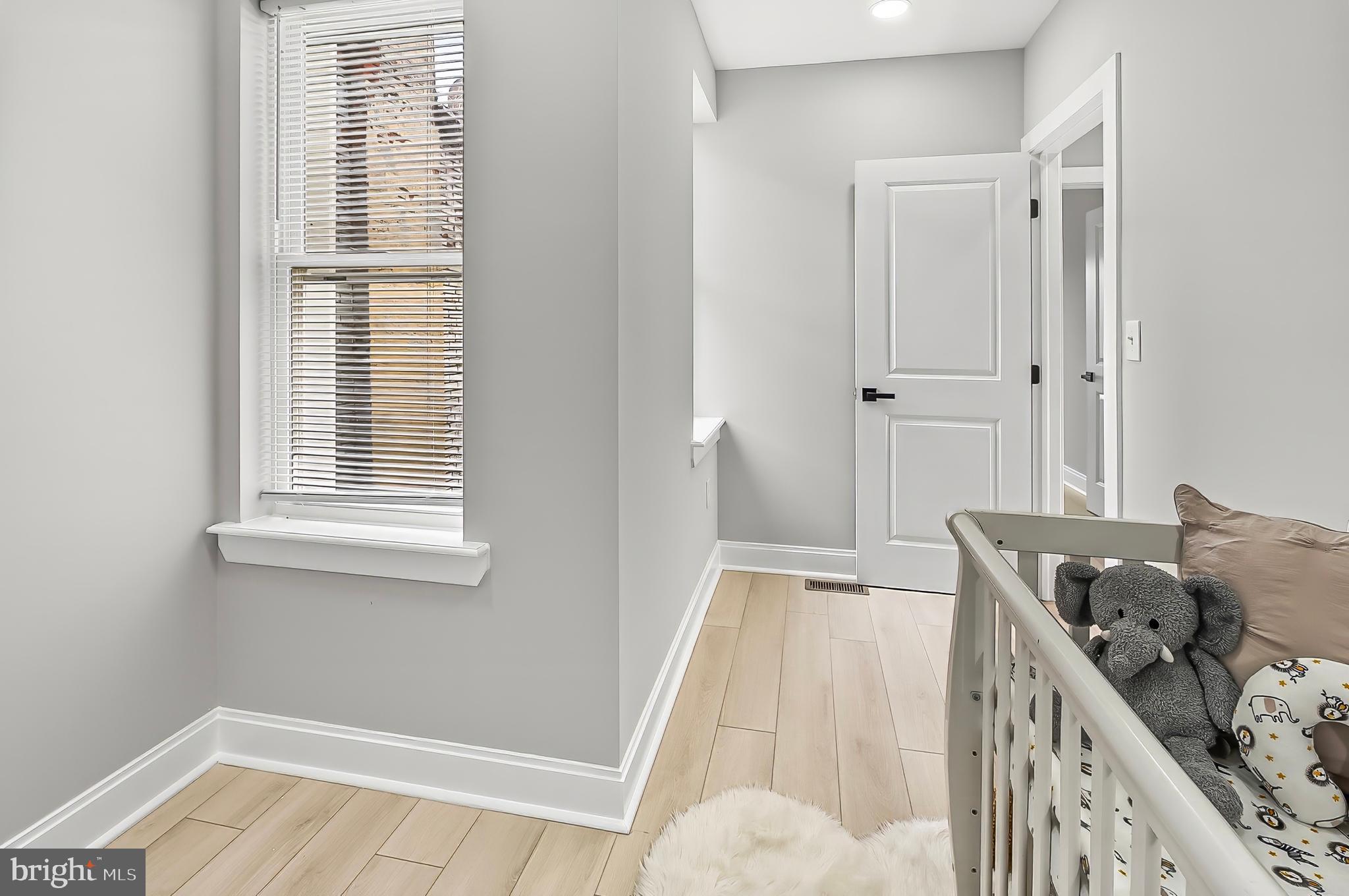 539 East 23rd Street Baltimore, MD 21218 - Photo 14 of 29 a view of a bedroom with furniture and windows