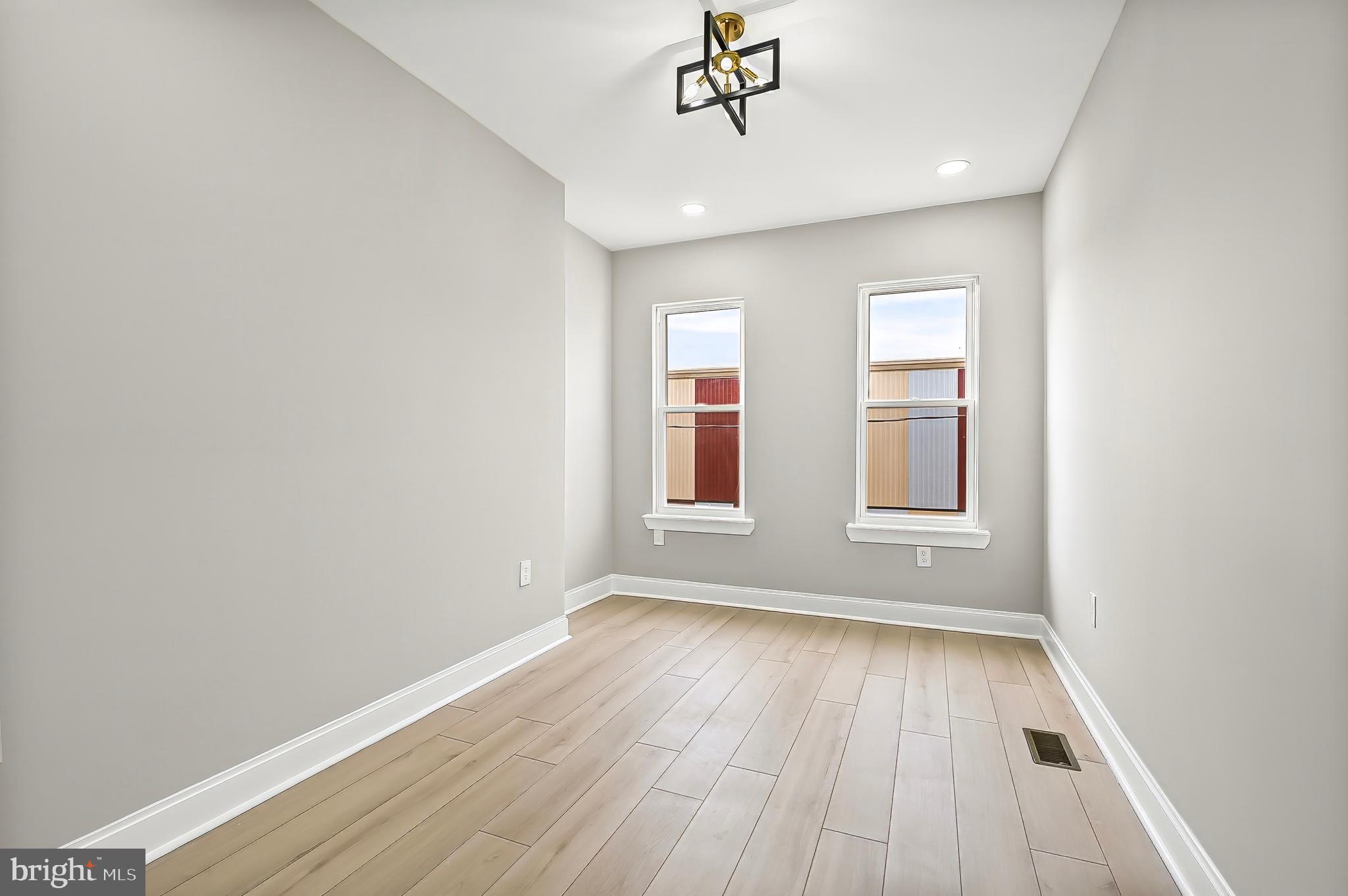 539 East 23rd Street Baltimore, MD 21218 - Photo 15 of 29 wooden floor in an empty room with a window