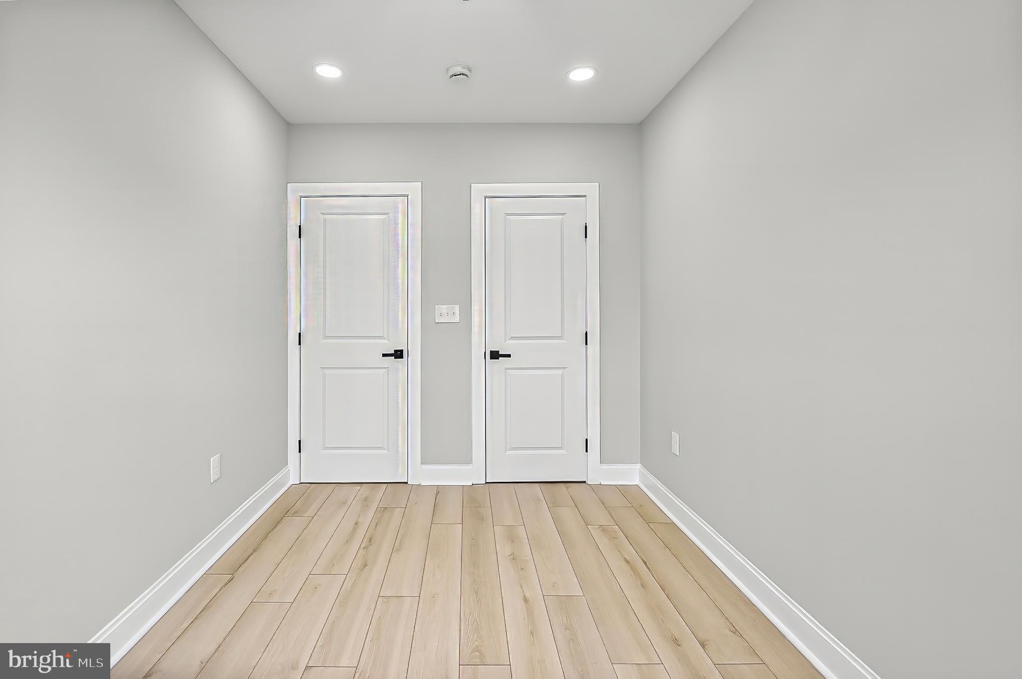 539 East 23rd Street Baltimore, MD 21218 - Photo 16 of 29 an empty room with wooden floor
