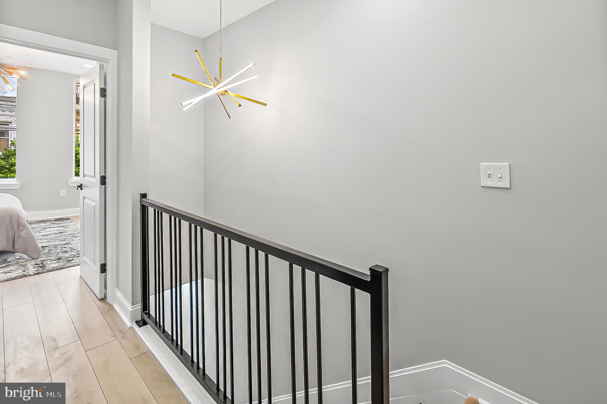 539 East 23rd Street Baltimore, MD 21218 - Photo 17 of 29 a view of a hallway with wooden floor and staircase