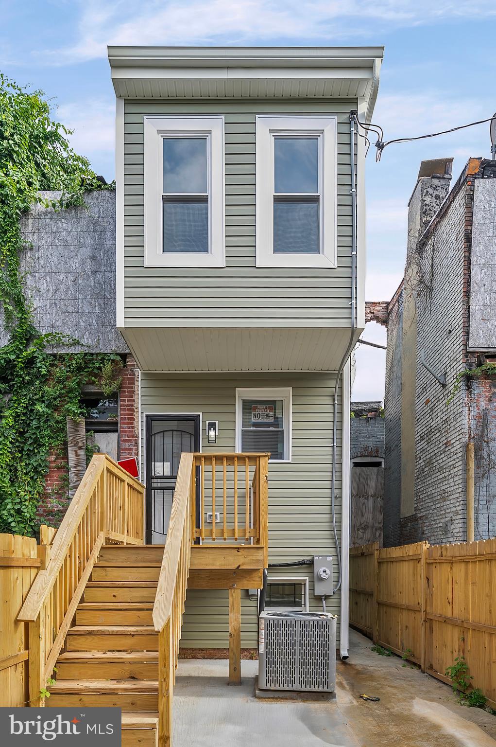 539 East 23rd Street Baltimore, MD 21218 - Photo 26 of 29 a view of a house with more windows and wooden fence