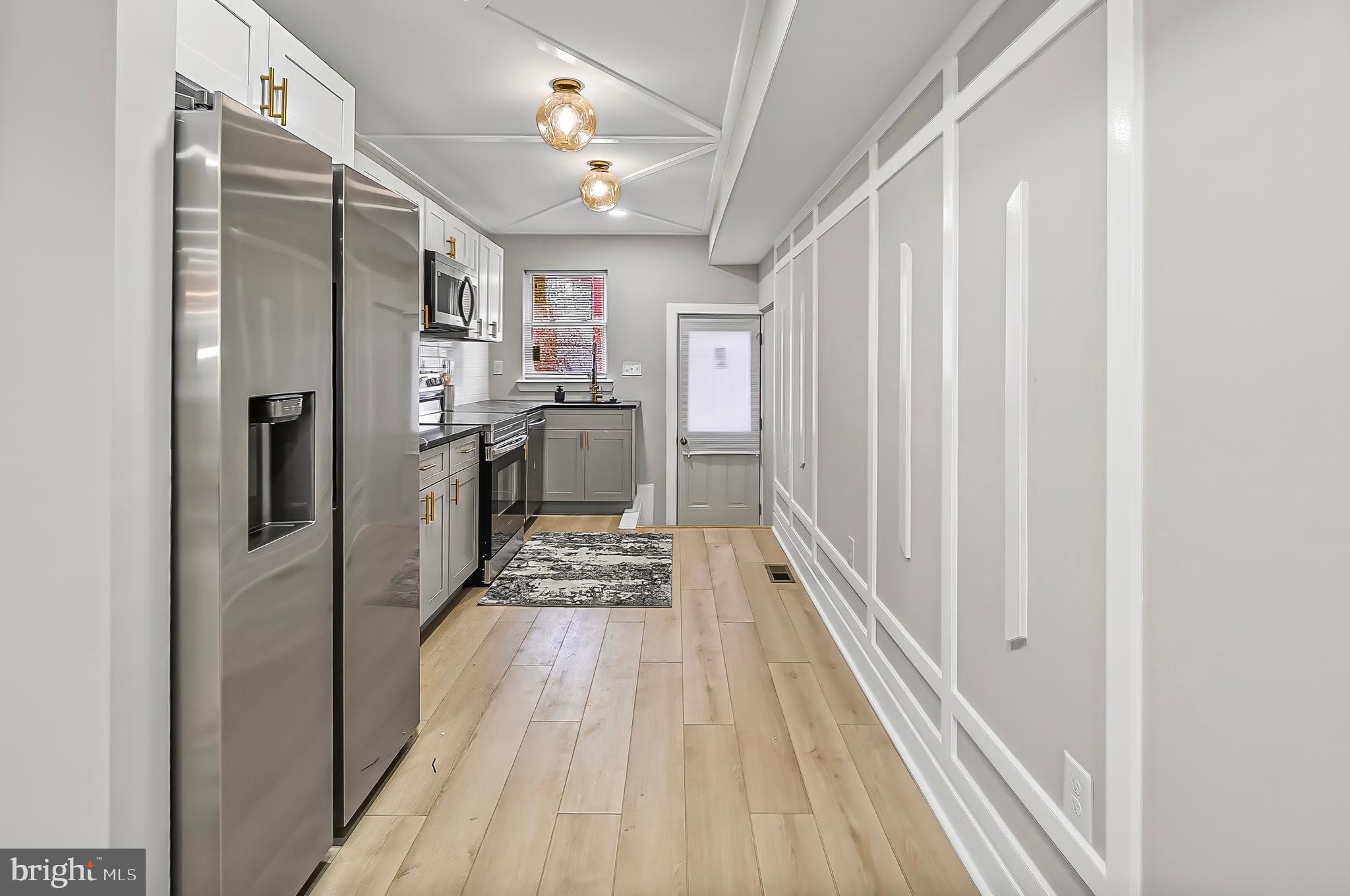 539 East 23rd Street Baltimore, MD 21218 - Photo 6 of 29 a kitchen with stainless steel appliances granite countertop a refrigerator and a sink