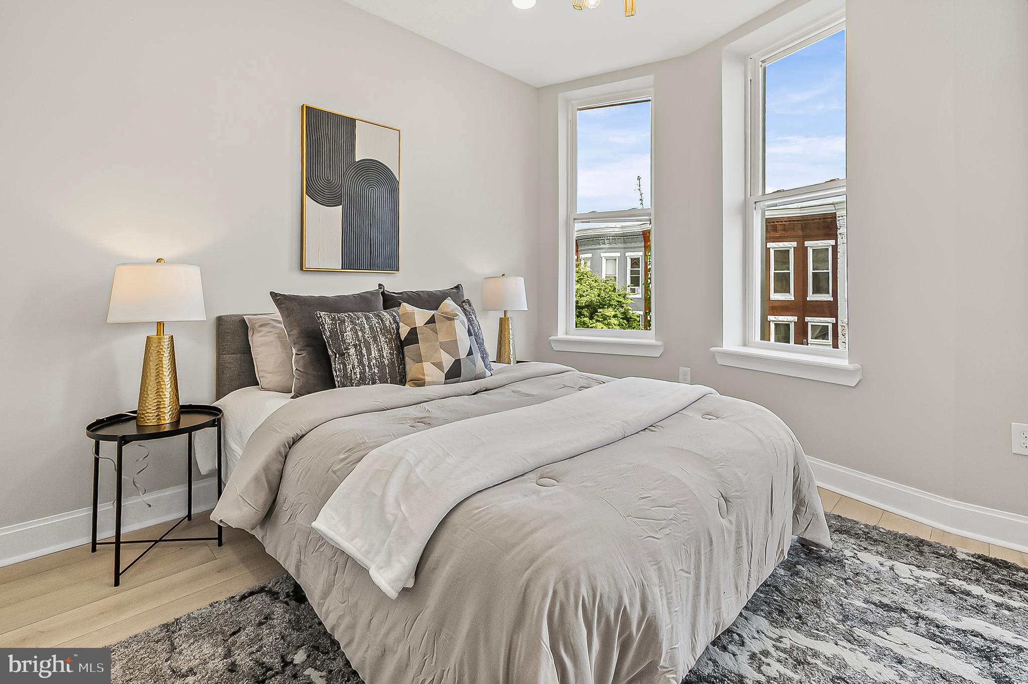 539 East 23rd Street Baltimore, MD 21218 - Photo 9 of 29 a bedroom with a bed and a night stand