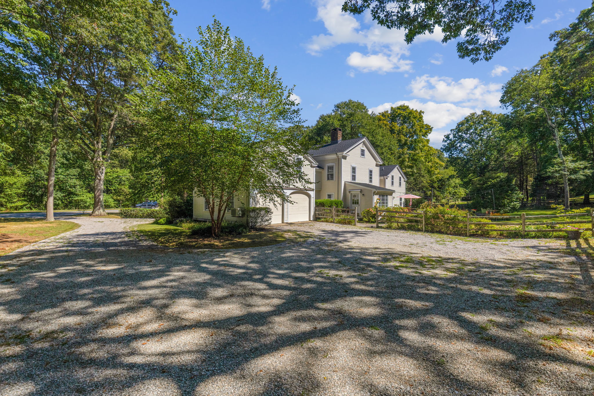 a front view of a house with a yard and trees