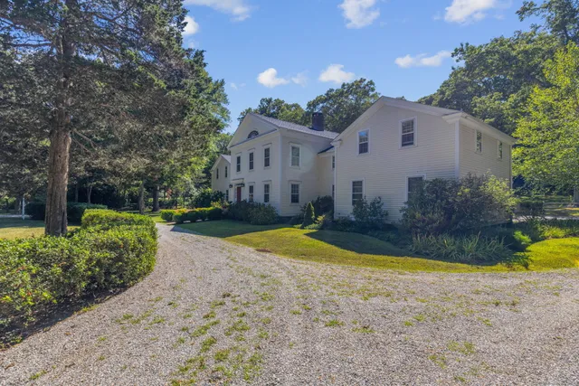 a large kitchen with stainless steel appliances granite countertop a sink a stove cabinets counter space and a window