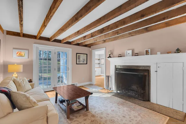 a view of a dining room with furniture a chandelier and wooden floor