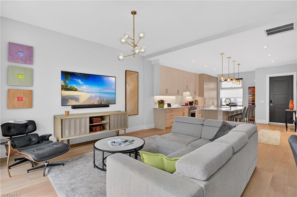 850 Central Avenue, Unit 208 Naples, FL 34102 - Photo 2 of 44 a living room with furniture kitchen view and a flat screen tv