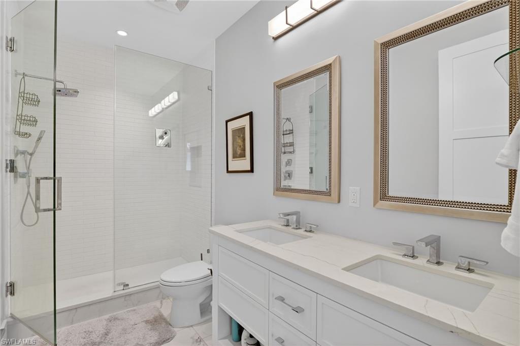 850 Central Avenue, Unit 208 Naples, FL 34102 - Photo 26 of 44 a bathroom with a sink toilet and shower
