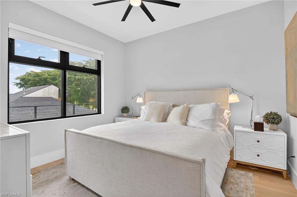 850 Central Avenue, Unit 208 Naples, FL 34102 - Photo 29 of 44 a bedroom with a large bed and a large window