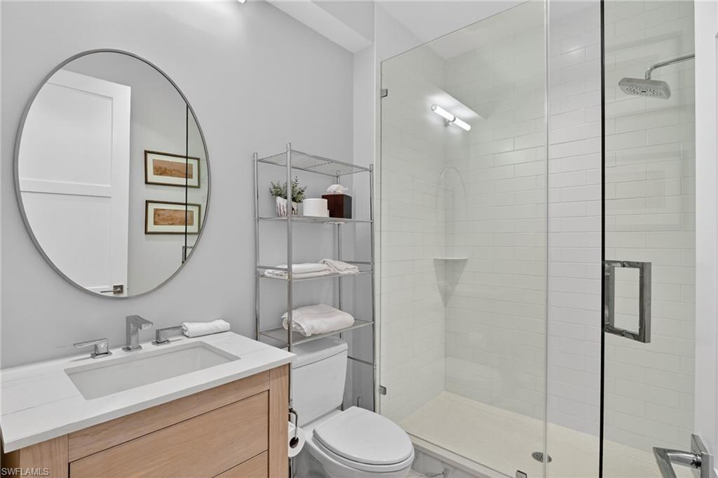 850 Central Avenue, Unit 208 Naples, FL 34102 - Photo 32 of 44 a bathroom with a sink toilet and shower