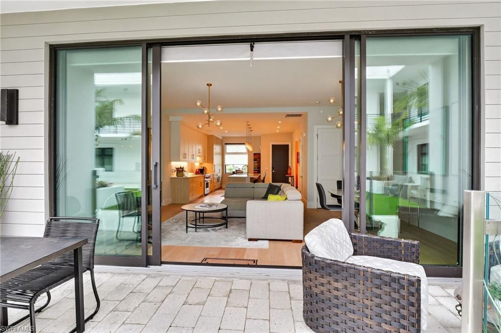 850 Central Avenue, Unit 208 Naples, FL 34102 - Photo 7 of 44 a living room with furniture and a potted plant