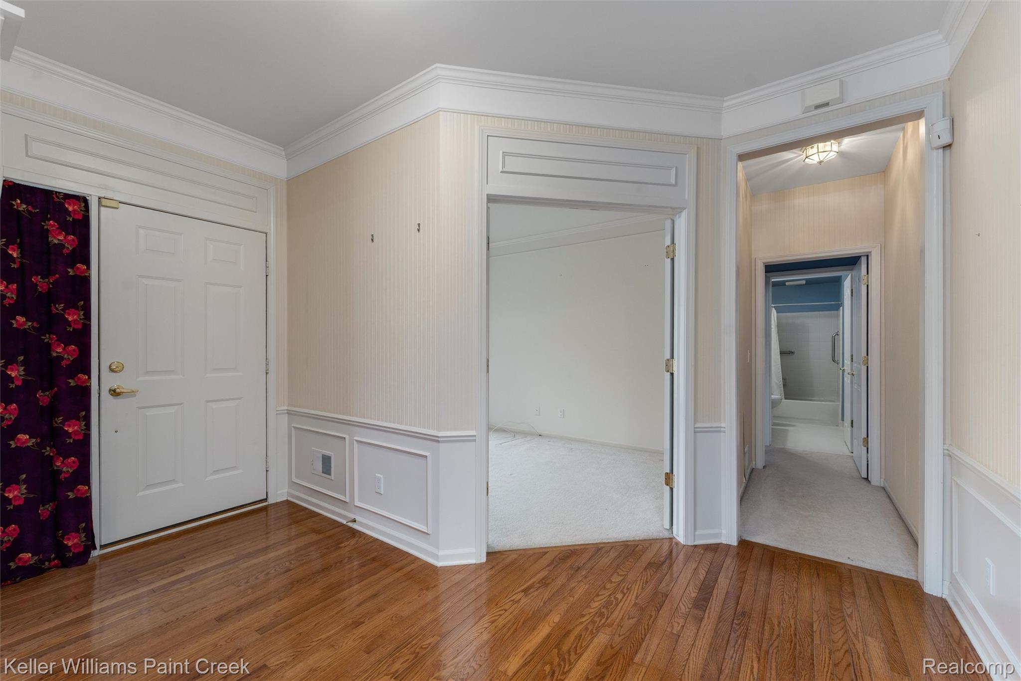 1685 Maple Creek Court Rochester, MI 48306 - Photo 4 of 49 Entrance foyer with hardwood / wood-style flooring, a decorative wall, ornamental molding, and wainscoting
