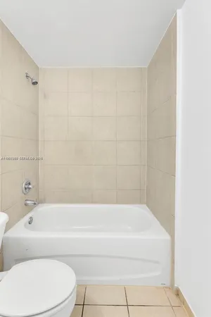 a bathroom with a bathtub and a toilet
