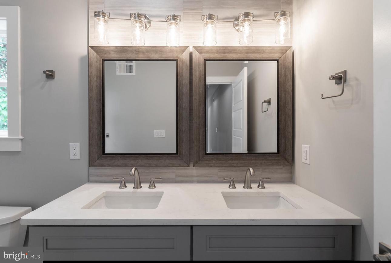1425 Hanson Street Philadelphia, PA 19143 - Photo 15 of 25 a bathroom with a sink and a mirror