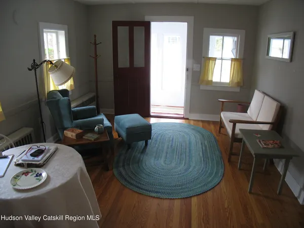 a living room with furniture and a mirror