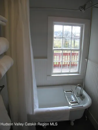 a view of a bathroom with bathtub and window